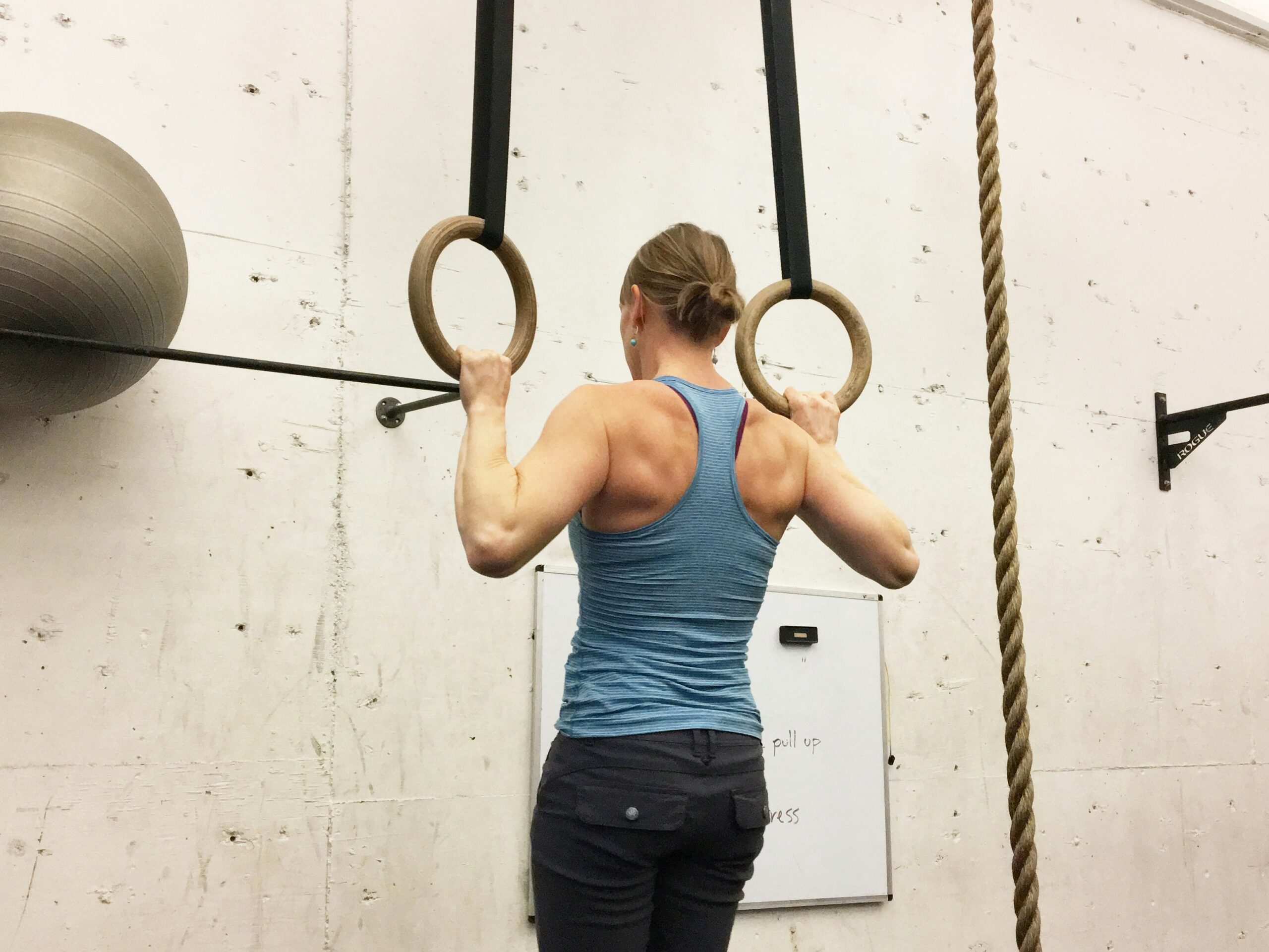 Beginner lifting dumbbells in gym as part of a strength training workout
