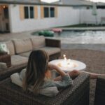 “A relaxed woman practicing mindfulness to lower cortisol naturally through meditation, nature, and herbal self-care”