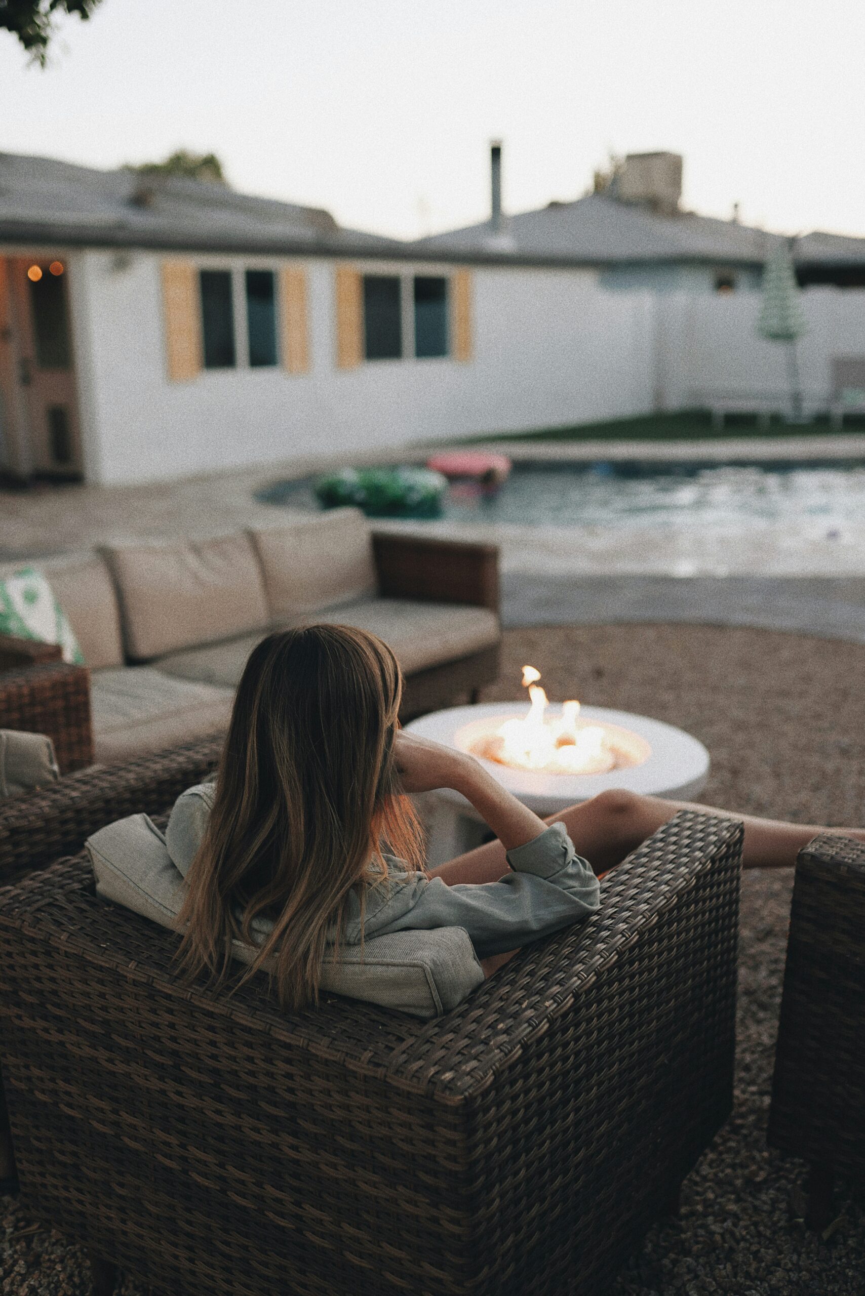 “A relaxed woman practicing mindfulness to lower cortisol naturally through meditation, nature, and herbal self-care”