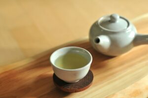"Green tea leaves and cup – supports fat burning and metabolism"