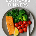 A healthy low-carb dinner plate featuring salmon, spinach, broccoli, and cherry tomatoes.