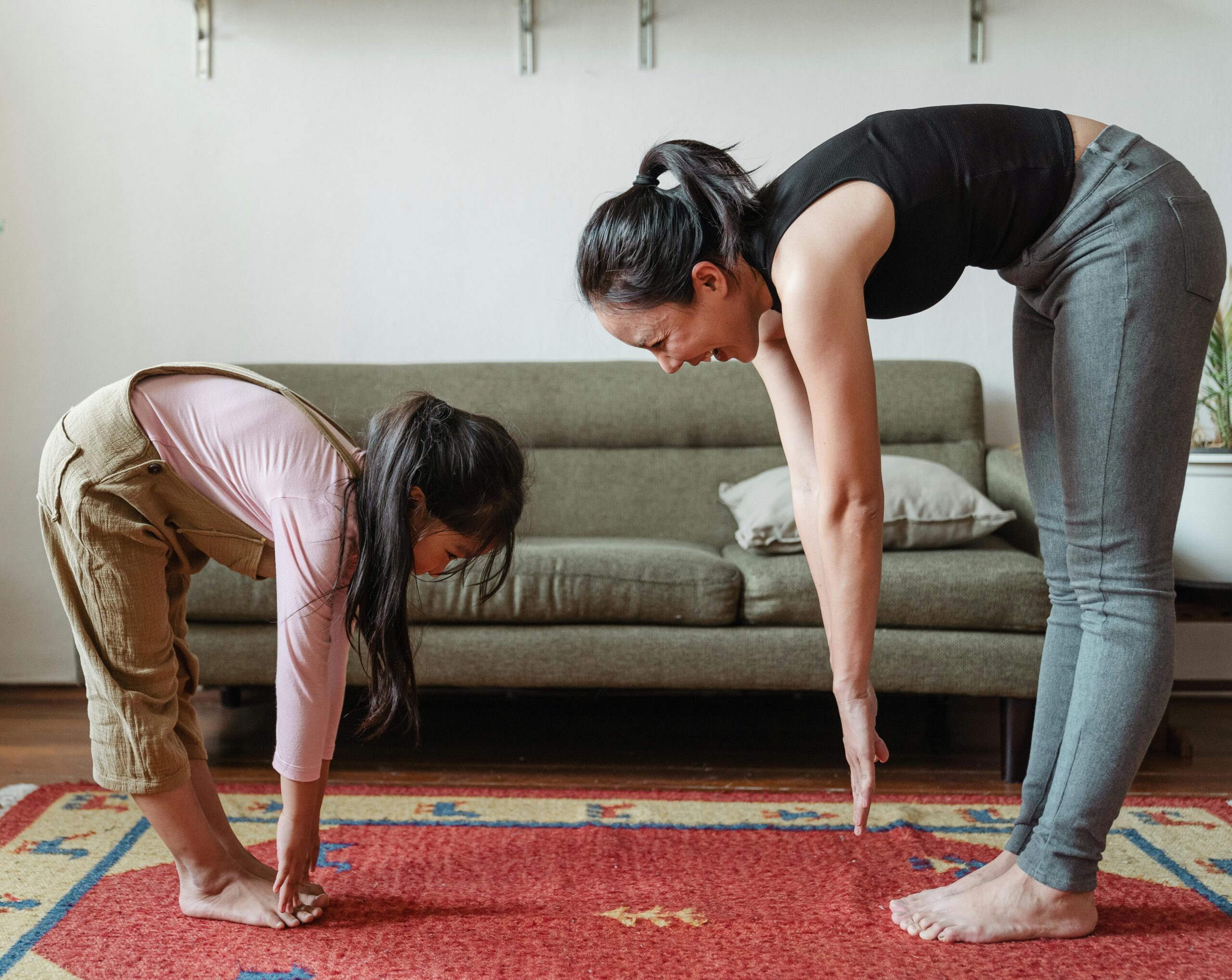 Middle-aged woman doing a home workout on a yoga mat with dumbbells, representing strength and fitness for women.